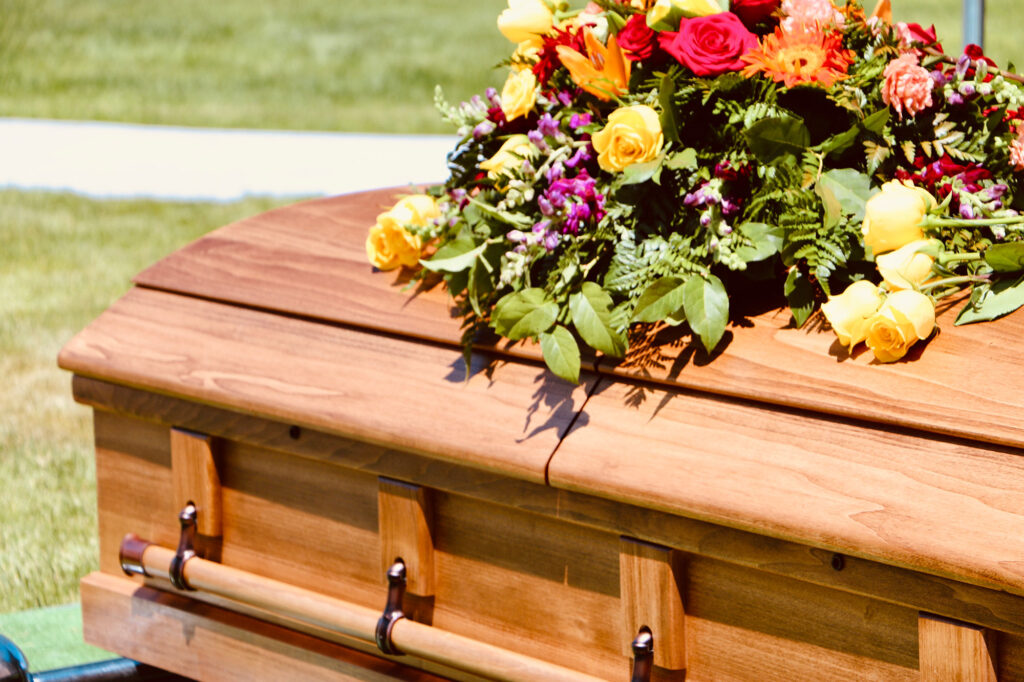 Floral Arrangement On Casket During A Burial