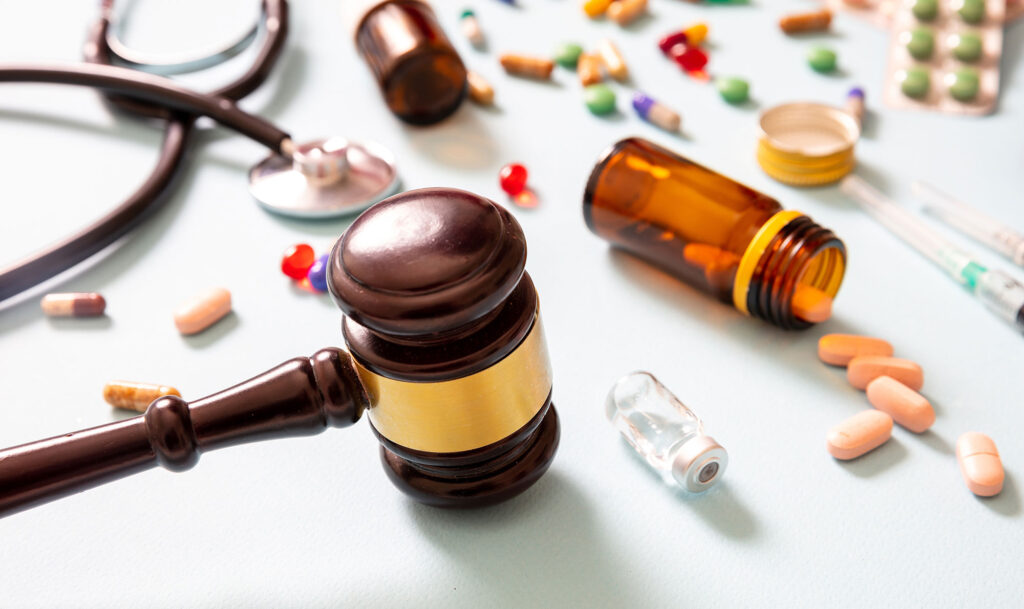 Image Showing Legal Gavel And A Host Of Medical Equipment And Drugs